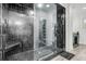 Luxurious bathroom featuring a spacious glass shower with dark tiling and a built-in bench at 1711 Indigo Island Dr, Hanahan, SC 29410