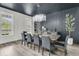 Elegant dining room featuring a long wooden table, stylish chairs, and modern lighting at 1711 Indigo Island Dr, Hanahan, SC 29410