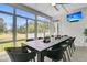 Enclosed sunroom with large dining table, ample seating, and outdoor views at 1711 Indigo Island Dr, Hanahan, SC 29410