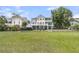Spacious backyard with a sprawling lawn and view of the home's multi-level decks and porches at 1711 Indigo Island Dr, Hanahan, SC 29410