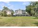 Expansive backyard with a sprawling lawn and view of the home's multi-level decks and porches at 1711 Indigo Island Dr, Hanahan, SC 29410