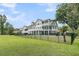 Spacious fenced yard featuring a lush lawn and view of the home's decks, pool, and fire pit at 1711 Indigo Island Dr, Hanahan, SC 29410