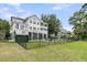 Expansive fenced yard featuring a lush lawn and view of the home's decks, pool, and fire pit at 1711 Indigo Island Dr, Hanahan, SC 29410