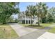 Elegant two-story home featuring a large driveway, lush landscaping, and classic architectural design at 1711 Indigo Island Dr, Hanahan, SC 29410