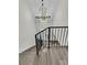 Elegant foyer showcases a modern chandelier and staircase with black metal railings at 1711 Indigo Island Dr, Hanahan, SC 29410