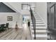 Grand foyer featuring a staircase with metal railings, hardwood floors, and an open living space at 1711 Indigo Island Dr, Hanahan, SC 29410