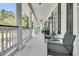 A spacious front porch with elegant columns, comfortable seating, and stylish decor at 1711 Indigo Island Dr, Hanahan, SC 29410