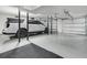 Spacious garage featuring epoxy flooring, car lift and ample space for vehicle and storage at 1711 Indigo Island Dr, Hanahan, SC 29410