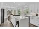 Bright modern kitchen with white cabinets, stainless appliances, large island, and breakfast nook at 1711 Indigo Island Dr, Hanahan, SC 29410
