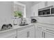 Modern kitchen features stainless steel appliances, white cabinets, and ample countertop space at 1711 Indigo Island Dr, Hanahan, SC 29410