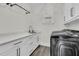 Clean laundry room with white cabinetry, modern appliances, and natural light at 1711 Indigo Island Dr, Hanahan, SC 29410