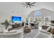 Airy living room featuring a vaulted ceiling, comfortable seating, and a large screen television at 1711 Indigo Island Dr, Hanahan, SC 29410
