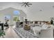 Vaulted living room with stylish furniture, large windows, and a view of the outdoors at 1711 Indigo Island Dr, Hanahan, SC 29410