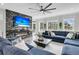 Cozy living room with a marble fireplace, TV, and a comfortable blue sectional sofa at 1711 Indigo Island Dr, Hanahan, SC 29410