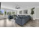 Spacious living room featuring a large sofa, wood floors, and bright natural lighting at 1711 Indigo Island Dr, Hanahan, SC 29410