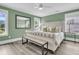 Tranquil bedroom with hardwood floors, abundant natural light, and a tufted headboard at 1711 Indigo Island Dr, Hanahan, SC 29410
