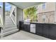Outdoor kitchen featuring stainless steel appliances and black cabinetry under a covered patio area at 1711 Indigo Island Dr, Hanahan, SC 29410
