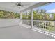 View of the porch with white rails and ceiling fan overlooking a scenic backyard at 1711 Indigo Island Dr, Hanahan, SC 29410
