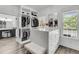 Spacious walk-in closet with island, bench seating and abundant storage at 1711 Indigo Island Dr, Hanahan, SC 29410