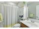 A well-lit bathroom with a shower/tub combo, and wood-look vanity at 1787 Tennyson Row # 9, Mount Pleasant, SC 29466