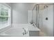 Bright bathroom featuring a large soaking tub, shower, and big window at 1787 Tennyson Row # 9, Mount Pleasant, SC 29466