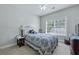 This bedroom boasts natural light, a ceiling fan, and a comfortable queen-size bed at 1787 Tennyson Row # 9, Mount Pleasant, SC 29466