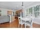 Bright dining area featuring a white table, white chairs, and natural light from a large window at 1787 Tennyson Row # 9, Mount Pleasant, SC 29466