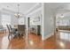 Open dining room with hardwood floors, modern lighting, and seamless flow to the living area at 1787 Tennyson Row # 9, Mount Pleasant, SC 29466