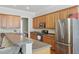 Open-concept kitchen with stainless steel appliances, wood cabinets and bar top seating at 1787 Tennyson Row # 9, Mount Pleasant, SC 29466