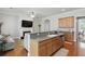 Open-concept kitchen and living room featuring wood cabinets, stainless steel appliances, bar seating and fireplace at 1787 Tennyson Row # 9, Mount Pleasant, SC 29466