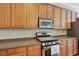 Bright kitchen with stainless steel appliances and light brown cabinets at 1787 Tennyson Row # 9, Mount Pleasant, SC 29466