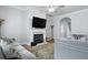 Bright living room featuring a fireplace, mounted TV, ceiling fan and hardwood floors at 1787 Tennyson Row # 9, Mount Pleasant, SC 29466