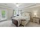 Well-lit main bedroom with trey ceilings, ceiling fan, and matching nightstand at 1787 Tennyson Row # 9, Mount Pleasant, SC 29466