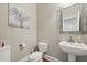 Stylish half bathroom with pedestal sink, decorative mirror, and contemporary finishes at 1787 Tennyson Row # 9, Mount Pleasant, SC 29466