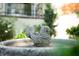 A close-up of a small decorative birdbath in the backyard at 19 Ashley Ave, Charleston, SC 29401