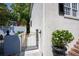 Side yard with black iron gate, stucco wall, and mature landscaping at 19 Ashley Ave, Charleston, SC 29401
