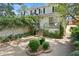 Backyard patio with lush landscaping, brick steps, and two story home with black shutters at 19 Ashley Ave, Charleston, SC 29401