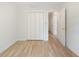 Bedroom with hardwood floors, white walls, closet, and doorway to hallway at 19 Ashley Ave, Charleston, SC 29401