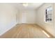 Bedroom with hardwood floors, white walls and trim, one window, and a closet at 19 Ashley Ave, Charleston, SC 29401