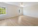 Bright, empty bedroom with hardwood floors and two windows at 19 Ashley Ave, Charleston, SC 29401