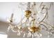 A close-up view of an elegant chandelier with crystal accents and ornate gold detailing at 19 Ashley Ave, Charleston, SC 29401