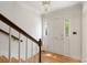 Bright foyer features hardwood floors, a chandelier, and a staircase, creating a welcoming entrance at 19 Ashley Ave, Charleston, SC 29401