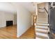 Foyer featuring hardwood floors, staircase, and views into the living room with fireplace at 19 Ashley Ave, Charleston, SC 29401