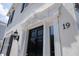 Elegant front door with decorative molding and black accents, adding a touch of sophistication at 19 Ashley Ave, Charleston, SC 29401