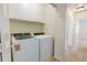 Laundry room with white cabinets, washer, and dryer and hallway access at 19 Ashley Ave, Charleston, SC 29401
