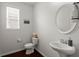 Stylish half bathroom with a pedestal sink, modern fixtures, and a decorative oval mirror at 203 Yeamans Way, Summerville, SC 29483