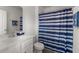 Bathroom with a striped shower curtain, white vanity and faucet at 203 Yeamans Way, Summerville, SC 29483