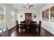 Formal dining room featuring hardwood floors, natural light from the windows, and elegant wood furniture at 203 Yeamans Way, Summerville, SC 29483