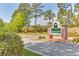 Community entrance sign with beautiful landscaping and well-maintained greenery at 203 Yeamans Way, Summerville, SC 29483