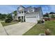 Charming two-story home with a front balcony, attached garage, and concrete driveway at 203 Yeamans Way, Summerville, SC 29483